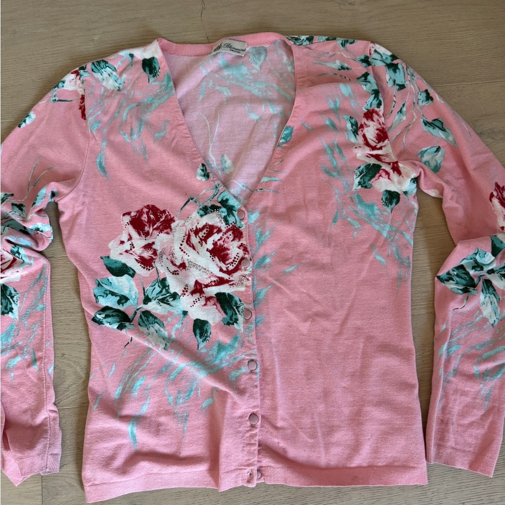 Pink Blumarine sweater with floral pattern and crystal details.
